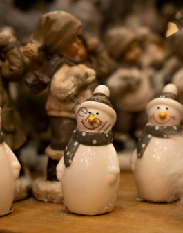 a group of snowmen sitting on top of a wooden table