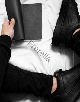 a person sitting on a bed holding a book