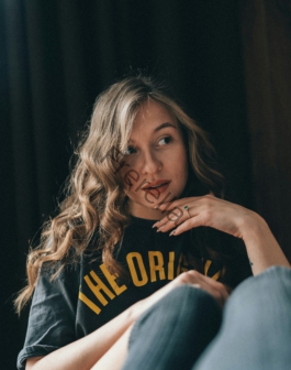 a woman sitting on a couch with her legs crossed
