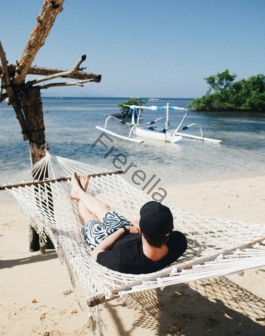 person lying on hammock during daytime