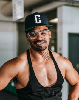 a man wearing a hat and glasses posing for a picture