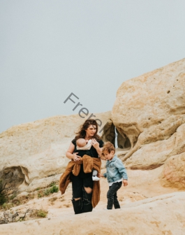 man and woman standing on brown rock formation during daytime