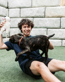 a man holding a dog on his lap