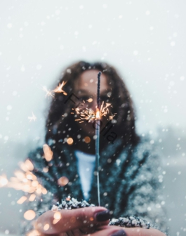 woman holding sparkler bokeh light