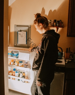 a person opens a refrigerator