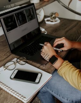 person in blue denim jeans using macbook pro