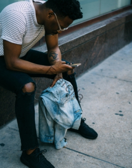 man sitting while using phone
