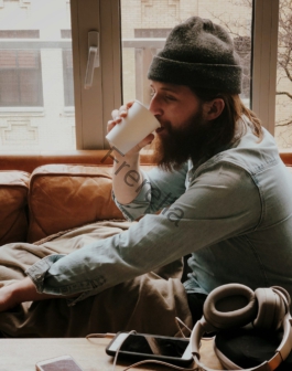 man sitting on sofa while drinking