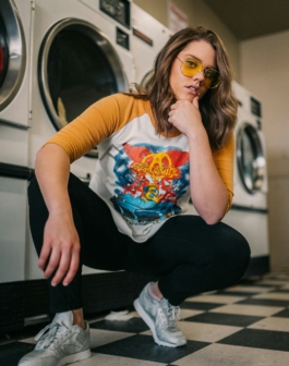 woman in white crew neck t-shirt and black pants sitting on black and white stairs