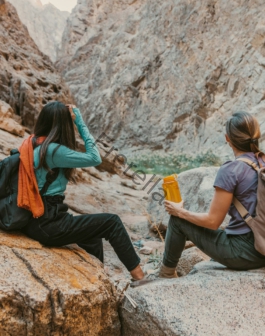 a group of people sitting on top of a rock