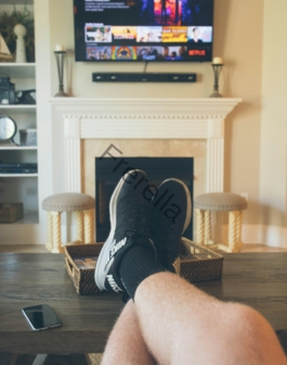 person wearing black shoes on seated near coffee table
