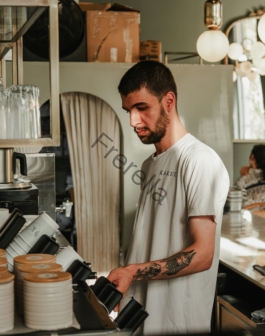 A man standing in a kitchen preparing food