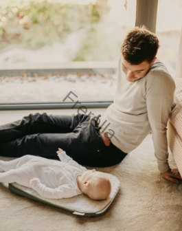 man in gray sweater lying on floor beside man in black shirt