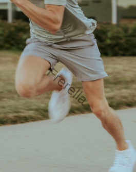 a man in grey shirt and shorts playing a game of tennis